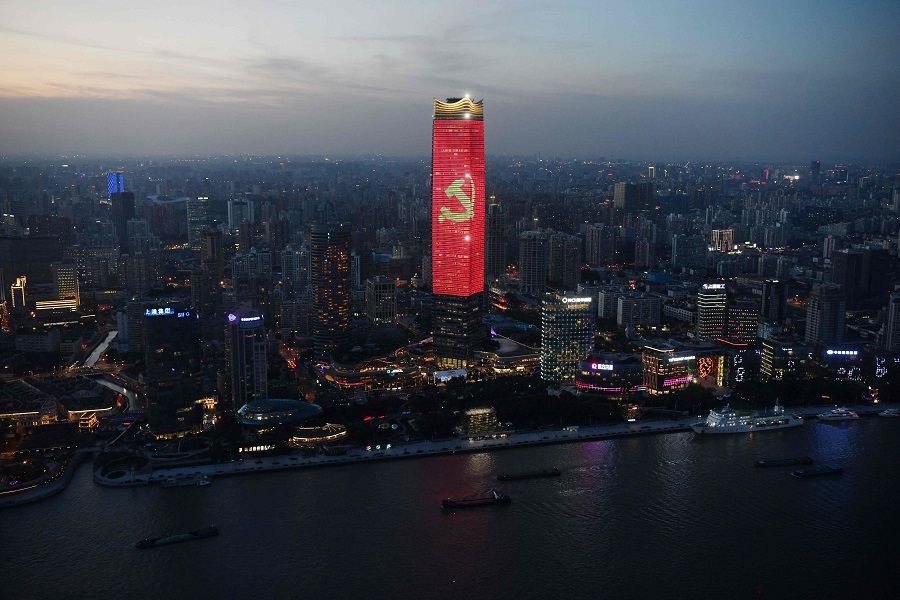 The Communist Party logo is seen on a skyscraper in Shanghai, China, at dusk on 31 August 2021. (Greg Baker/AFP)