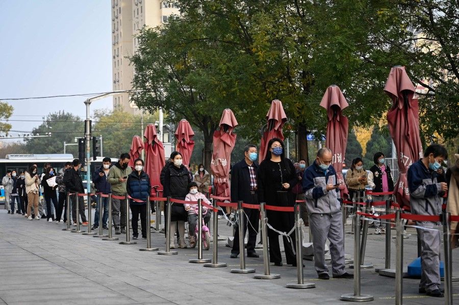 People wait in line to be tested for Covid-19 at a nucleic acid testing station in Beijing on 10 November 2022. (Jade GaoAFP)