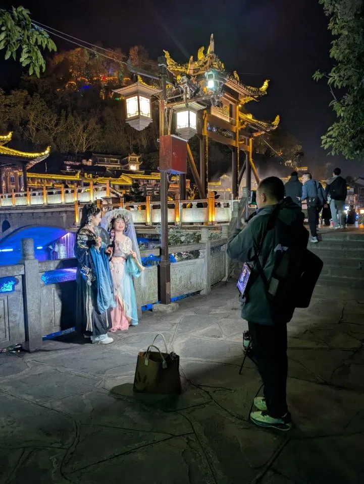 Professional travel photography services in Fenghuang old town.