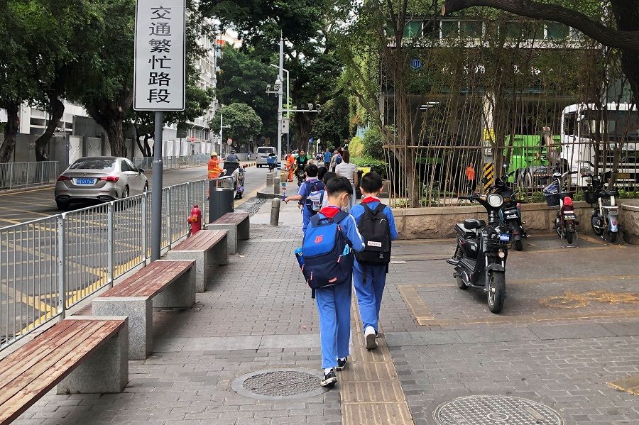 Children leave a school in Shekou area of Shenzhen, Guangdong province, China, 20 April 2021. (David Kirton/Reuters)