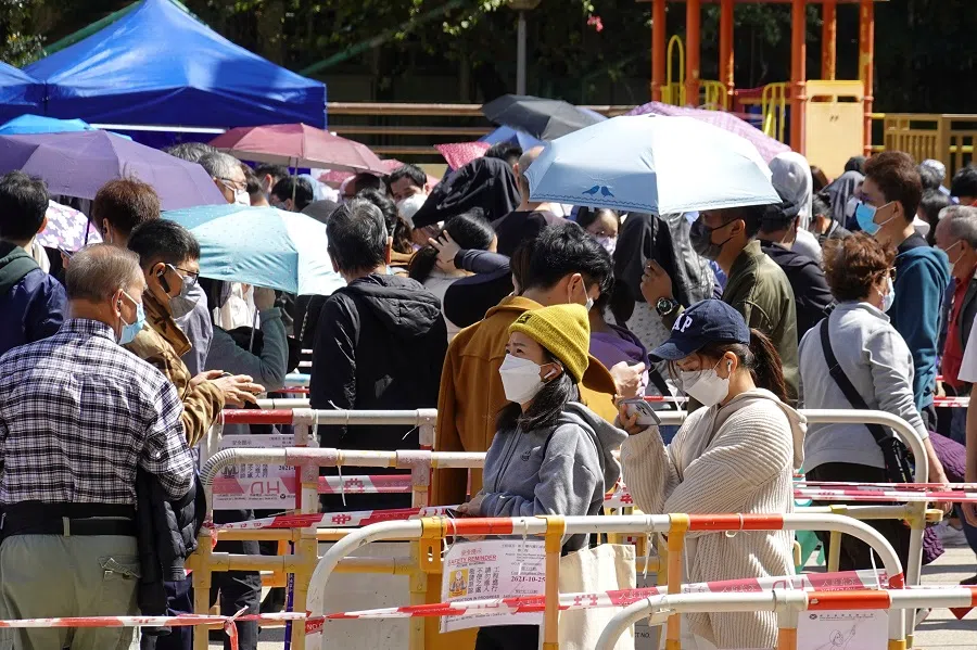 People line up at a makeshift testing site for Covid-19 following the outbreak, in Hong Kong, China, 11 February 2022. (Joyce Zhou/Reuters)