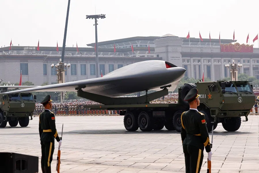 Members of the People's Liberation Army stand as unmanned operations group display a drone during a military parade to mark the 80th anniversary of the end of World War Two, in Beijing, China, 3 September 2025. (Tingshu Wang/Reuters)