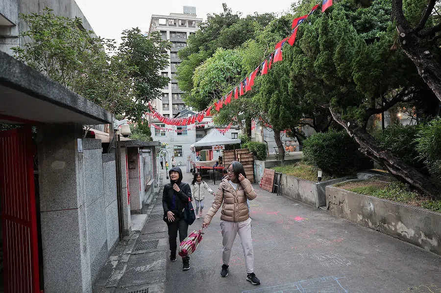 People walk in New Taipei city, Taiwan, 9 December 2024. (Ann Wang/Reuters)