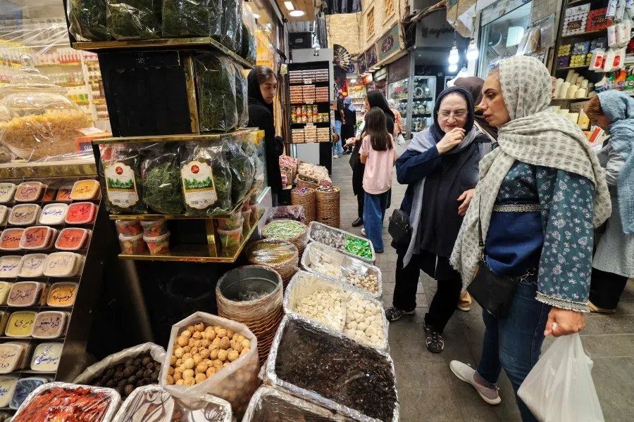 Women shop at a dried fruit and nuts store at Tajrish Bazaar in the Iranian capital Tehran on 30 June 2025. (Atta Kenare/AFP)