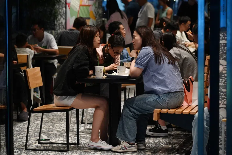 People sit at a restaurant in a shopping mall in Beijing, China, on 16 September 2024. (Greg Baker/AFP)