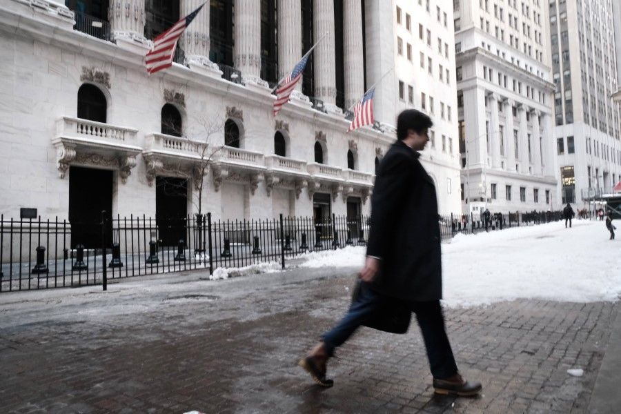 People walk by the New York Stock Exchange (NYSE) on 31 January 2022 in New York City. (Spencer Platt/Getty Images/AFP)