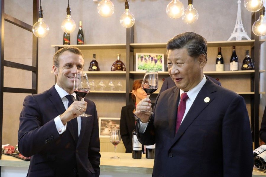 China's President Xi Jinping (R) and French President Emmanuel Macron (L) at the China International Import Expo in Shanghai on November 5, 2019. President Xi previously said private companies and entrepreneurs are "one of us". (ludovic Marin/AFP)