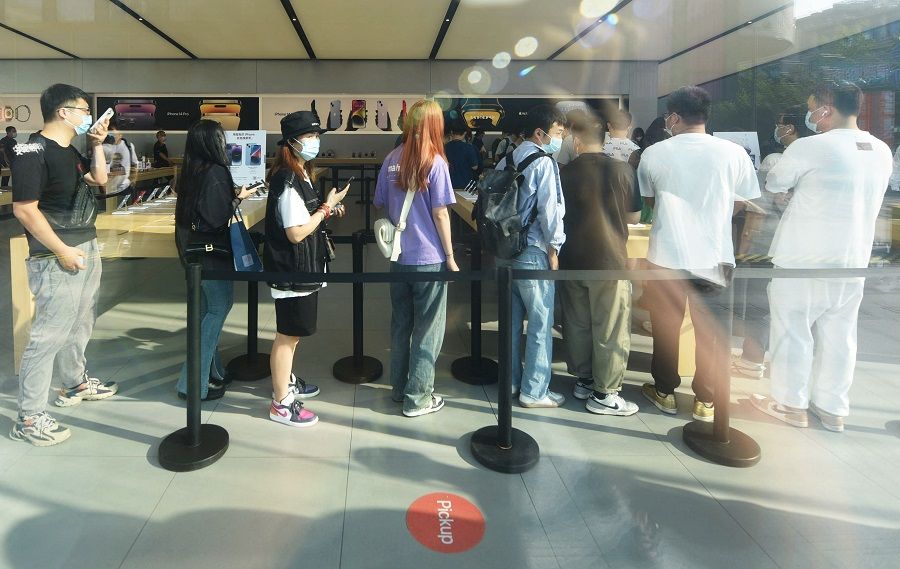 Customers queue to get newly-launched iPhone 14 mobile phones at an Apple store in Hangzhou, Zhejiang province, China, on 16 September 2022. (AFP)