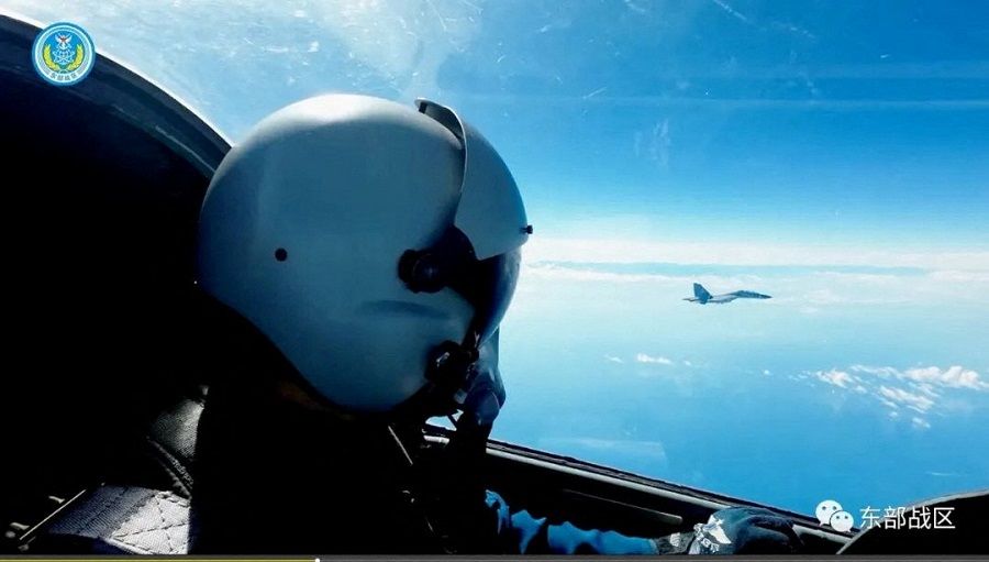 An Air Force pilot navigates an aircraft next to a fighter jet under the Eastern Theater Command of China's People's Liberation Army (PLA) during military exercises in the waters and airspace around Taiwan, at an undisclosed location, 9 August 2022, in this handout image released on 10 August 2022. (Eastern Theater Command/Handout via Reuters)