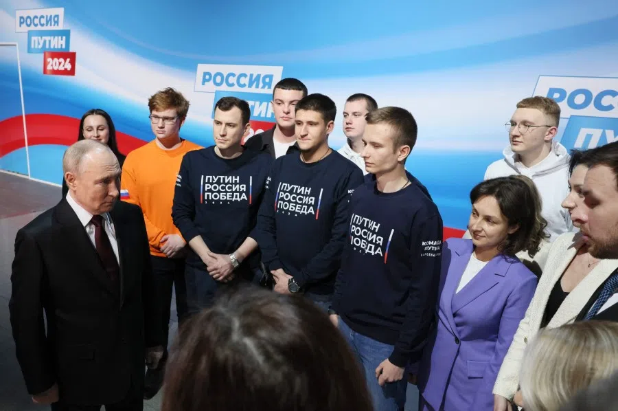 In this pool photograph distributed by Russia's state agency Sputnik, Russian President Vladimir Putin meets with his confidants and volunteers at his campaign headquarters in Moscow on 17 March 2024. (Mikhail Metzel/AFP)