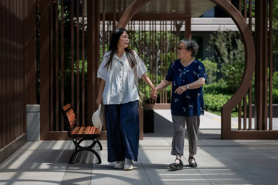 Zhang Xiuying (right) and her daughter-in-law Fang Ziluan in the garden of the Perennial Eldercare Community in Tianjin on 3 June 2025.