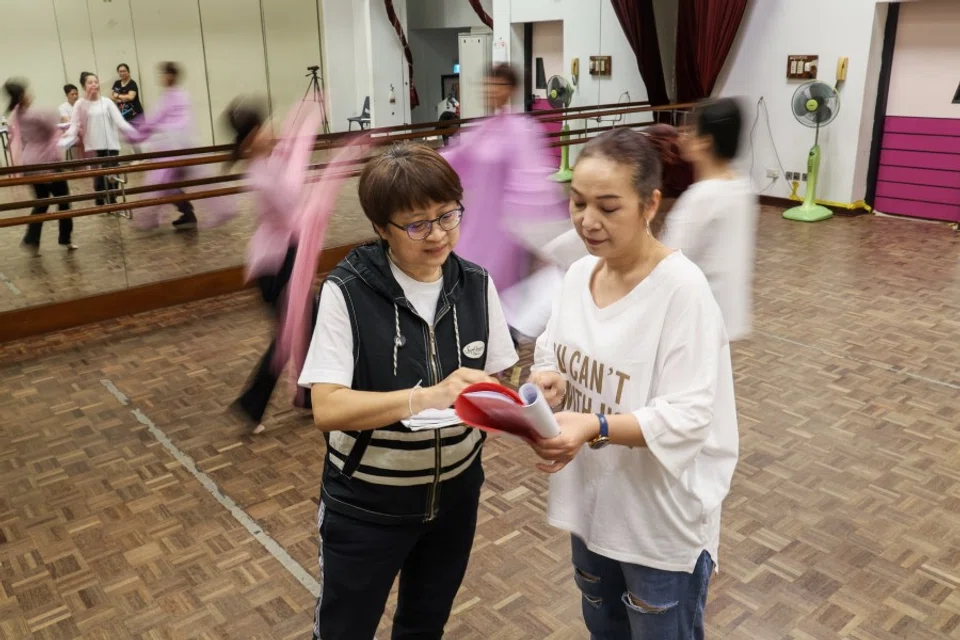 Playwright Teo Sung Lung (left) and director Cai Bixia (right) have a discussion during a rehearsal of When The Narcissus Blooms. (SPH Media)