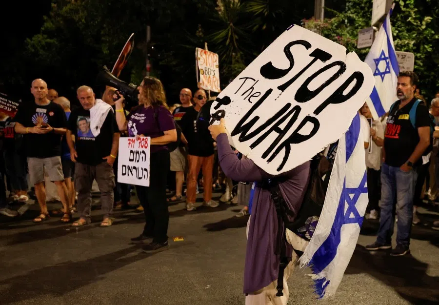 A demonstrator holds a sign during a protest demanding the immediate release of the hostages who were kidnapped during the deadly 7 October 2023 attack on Israel by Hamas, near Israeli Prime Minister Benjamin Netanyahu’s residence in Jerusalem, on 16 September 2025.