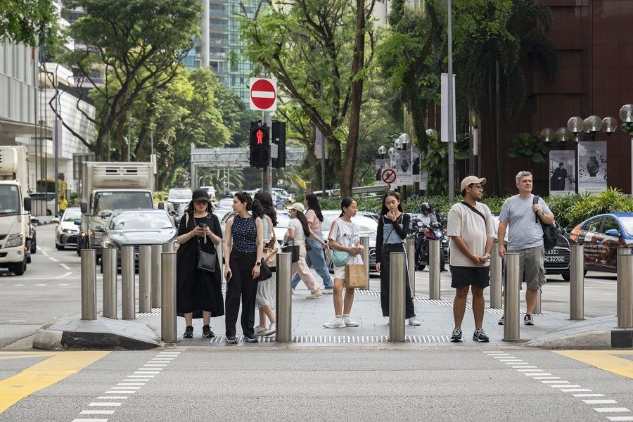 Pedestrians at a crossing on Orchard Road in Singapore, on 20 November 2023. (Lauryn Ishak/Bloomberg)