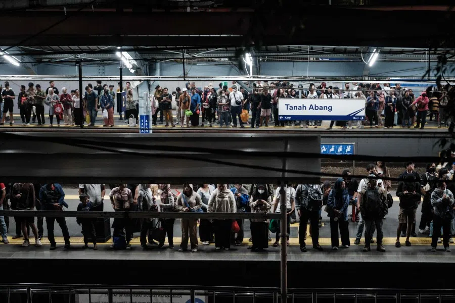 People waiting for a train on the platform at Tanah Abang station in Jakarta on 26 July 2025. (Yasuyoshi Chiba/AFP)