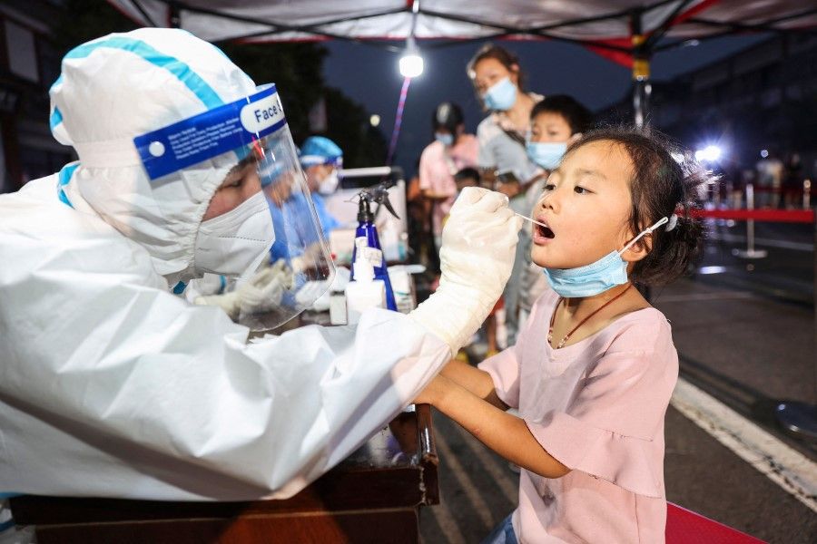 This photo taken on 17 August 2021 shows a child receiving a nucleic acid test for the Covid-19 coronavirus in Lianyungang in China's eastern Jiangsu province. (STR/AFP)