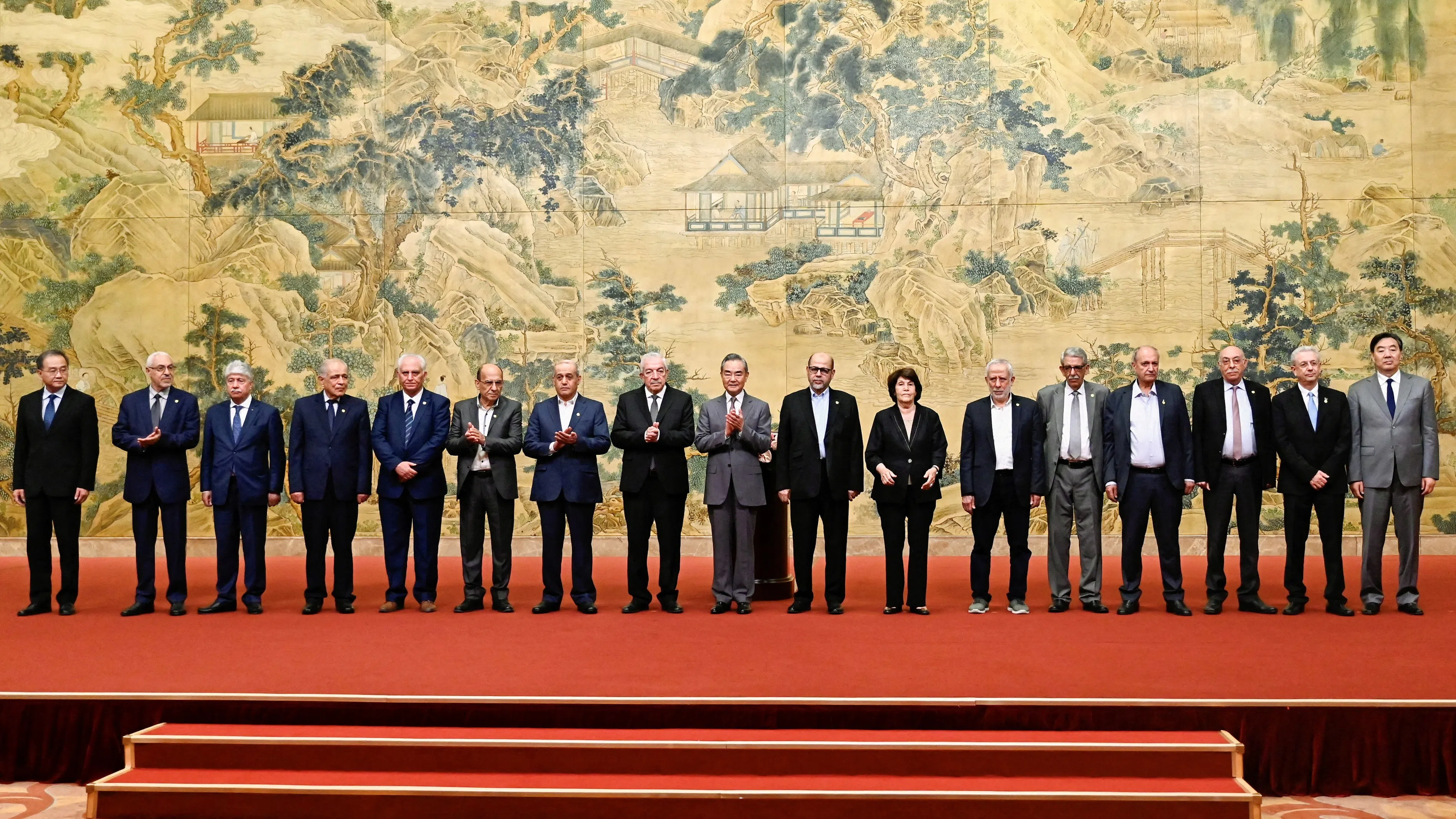 China’s Foreign Minister Wang Yi poses for a group picture with members of the Palestinian factions during the signing of the “Beijing Declaration” at the Diaoyutai State Guesthouse in Beijing on 23 July 2024.
