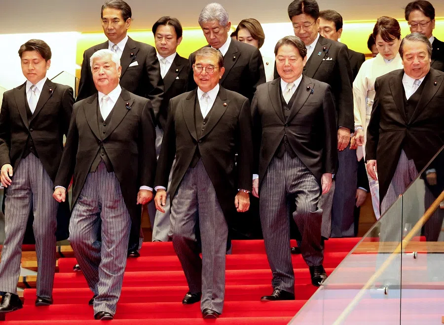 Japan’s new Prime Minister Shigeru Ishiba (front row, centre) arrives with members of his cabinet for a photo session at the prime minister’s official residence in Tokyo on 11 November 2024.