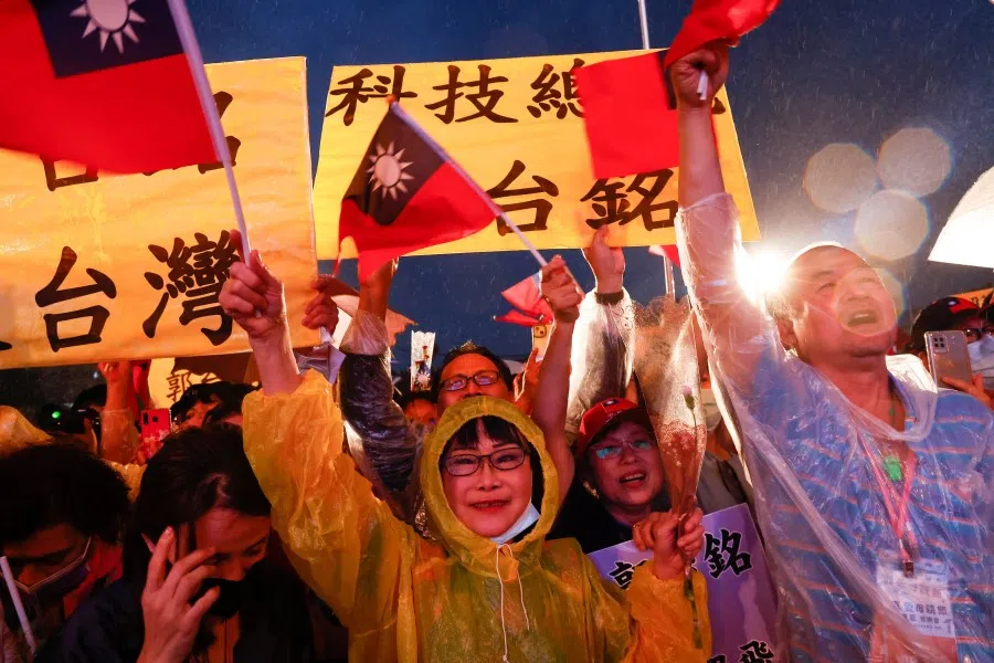 Fans of Foxconn founder Terry Gou wave Taiwanese flags during a campaign rally in New Taipei City, Taiwan, 12 May 2023. (Ann Wang/Reuters)