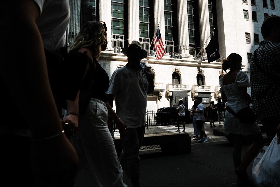 People walk past the New York Stock Exchange in New York City, US, on 12 July 2023. (Spencer Platt/Getty Images/AFP)
