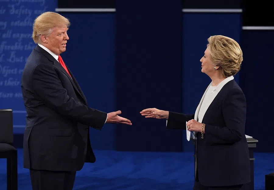 US Democratic presidential candidate Hillary Clinton and US Republican presidential candidate Donald Trump shakes hands after the second presidential debate at Washington University in St. Louis, Missouri, on 9 October 2016. (Robyn Beck/AFP)