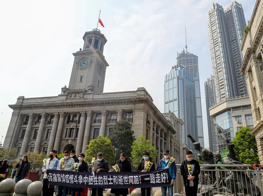 People observe a moment of silence outside Hankou Customs House where the Chinese national flag flies at half mast, in Wuhan, Hubei province, on 4 April 2020. (CNS photo via Reuters)