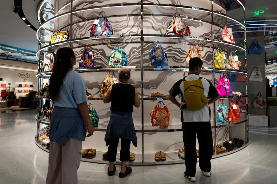 People look at colorful bags on display at a bag store in a shopping mall in Beijing, China, on 8 July 2026.