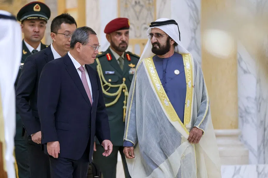 A handout image provided by United Arab Emirates News Agency (WAM) shows Prime Minister Mohamed bin Rashid al-Maktoum (R) speaking with his counterpart from China Li Qiang in Abu Dhabi on 12 September 2024. Li arrived in the UAE as part of a regional Gulf trip that started in neighbouring Saudi Arabia. (WAM/AFP)