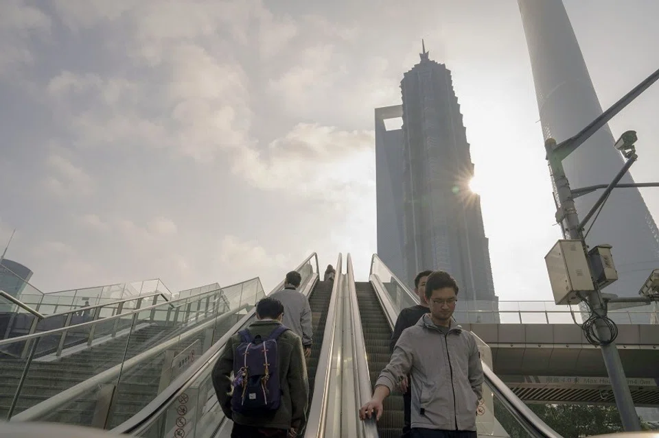 Pedestrians ride escalators in Pudong's Lujiazui financial district in Shanghai, China, on 29 January 2024. (Raul Ariano/Bloomberg)