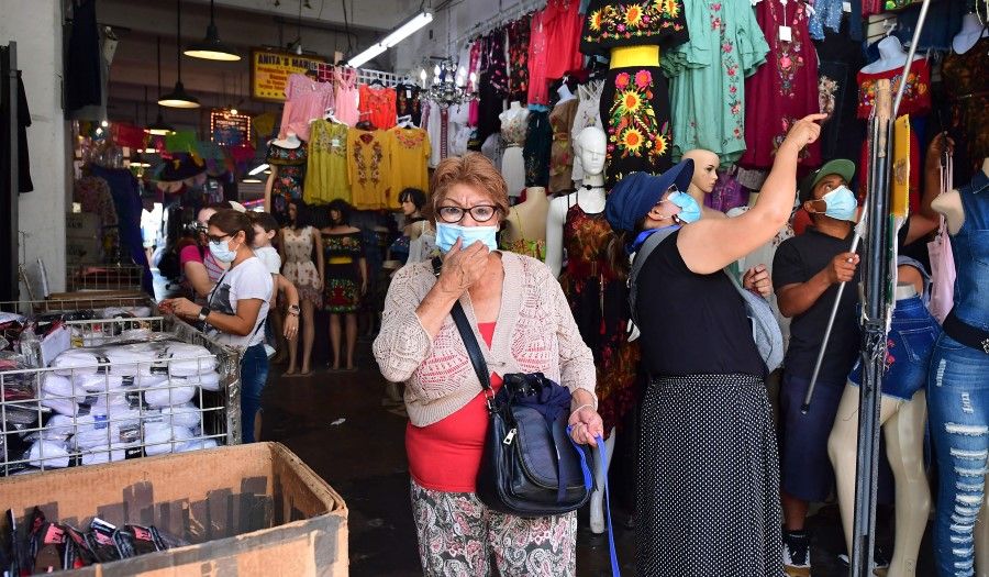 People shop in a clothing store on 19 July 2021 in Los Angeles, California. (Frederic J. Brown/AFP)