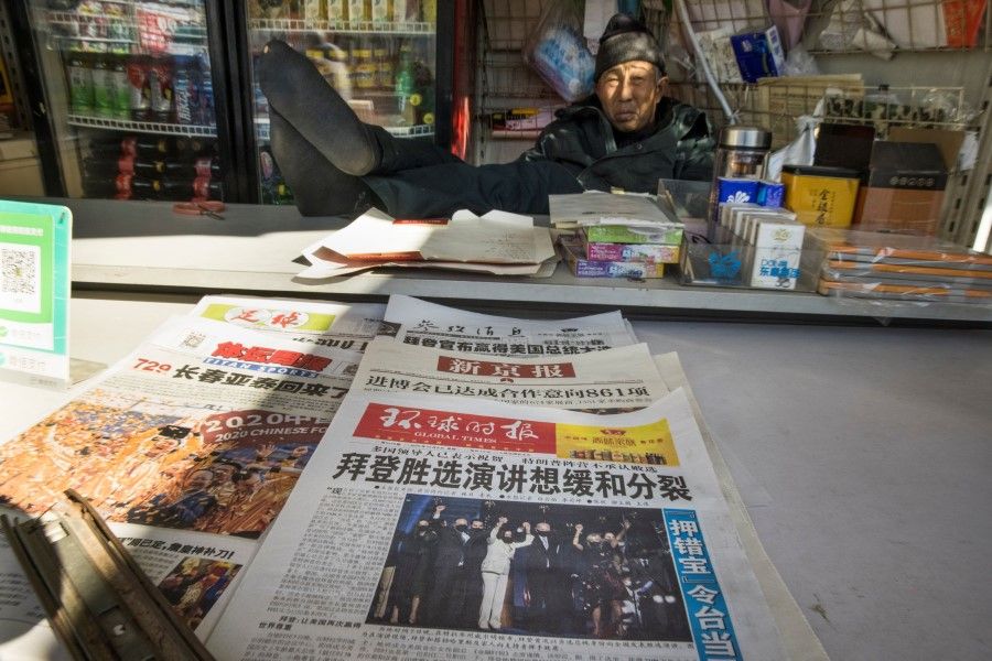 The front page of the Global Times newspaper shows a picture of US President-elect Joe Biden and Vice President-elect Kamala Harris at a newsstand in Beijing, China, 9 November 2020. The headline reads on the paper reads: "Biden's election speech discusses easing divisions." (Thomas Peter/REUTERS)