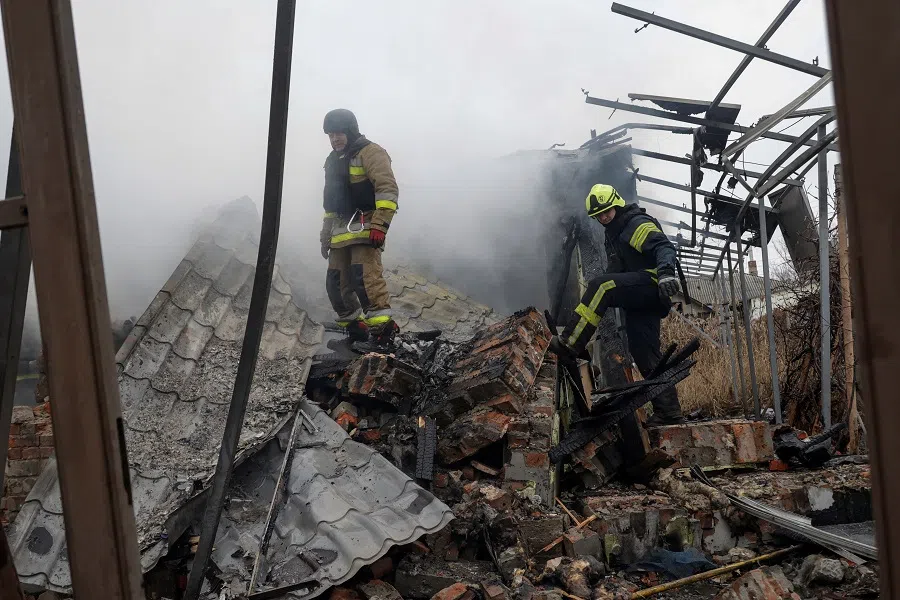 Firefighters work at the site of residential buildings hit by a Russian drone strike, amid Russia’s attack on Ukraine, in Kharkiv, Ukraine, on 25 December 2024. (Sofiia Gatilova/Reuters)