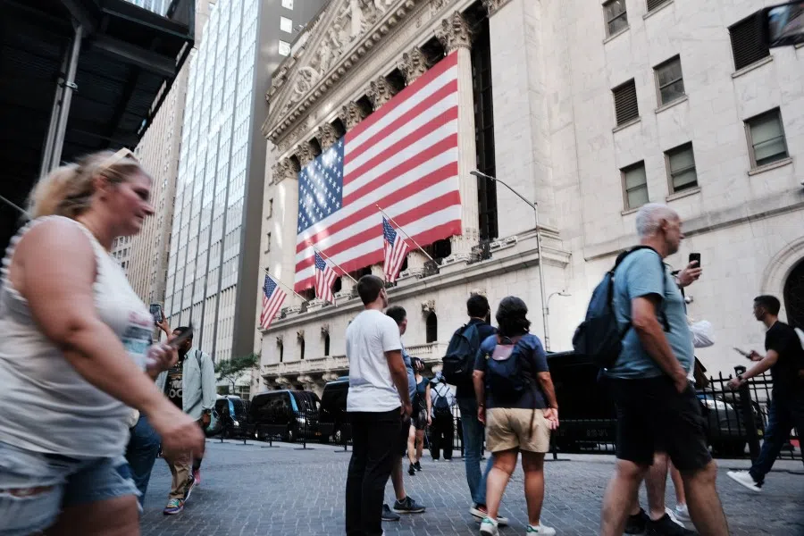 People walk by the New York Stock Exchange (NYSE) on 1 September 2022 in New York City. (Spencer Platt/Getty Images/AFP)
