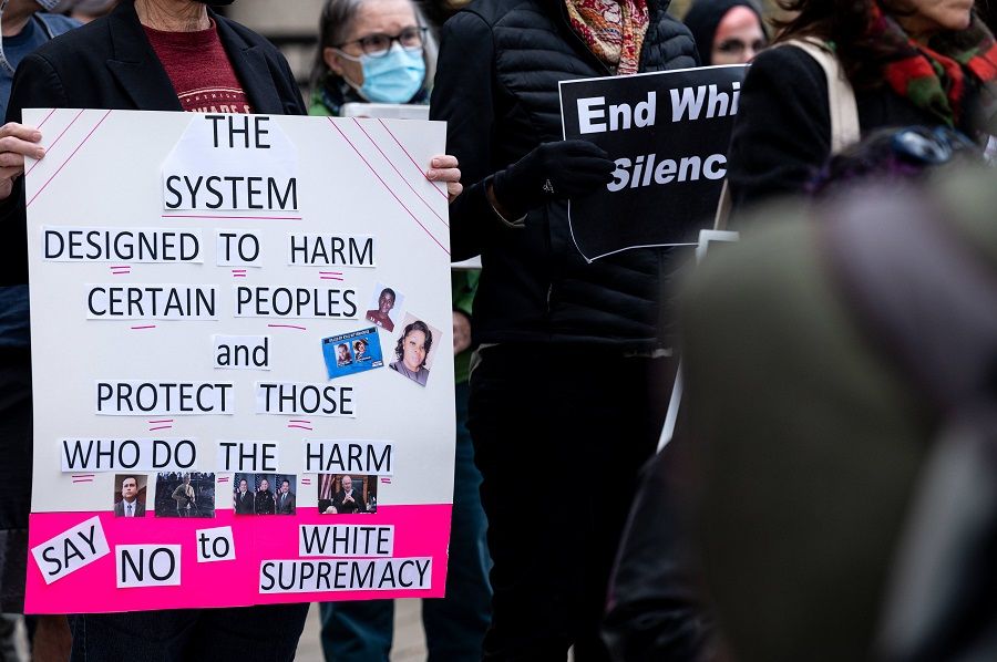 A protester with a sign is seen outside of the Hall of Justice during the Reject the Verdict rally on 20 November 2021 in Louisville, Kentucky, US. (Jon Cherry/Getty Images/AFP)