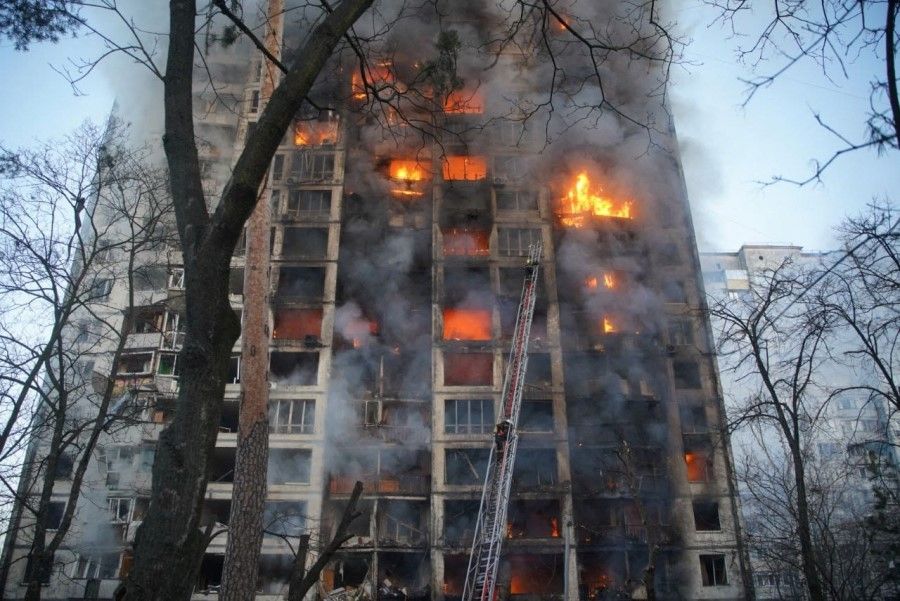 Rescuers work next to a residential building damaged by shelling, as Russia's attack on Ukraine continues, in Kyiv, Ukraine, in this handout picture released 15 March 2022. (Press service of the State Emergency Service of Ukraine/Handout via Reuters)
