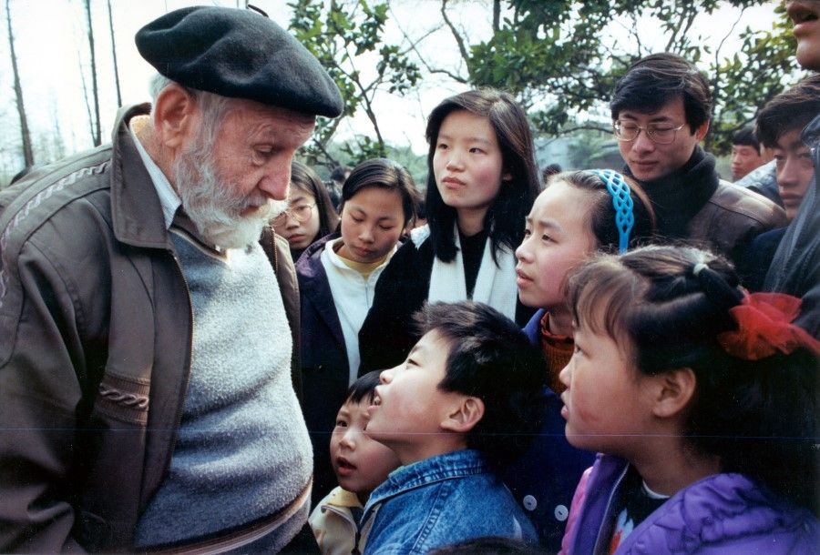 The English Corner at People's Park in Shanghai, 1994. A group of children surround a foreign tourist and practice their English by speaking with him in simple conversation. In the 1990s, there was a wave of English learning in China - besides strengthening one's job prospects, it also symbolised the Chinese people's desire to engage the world.