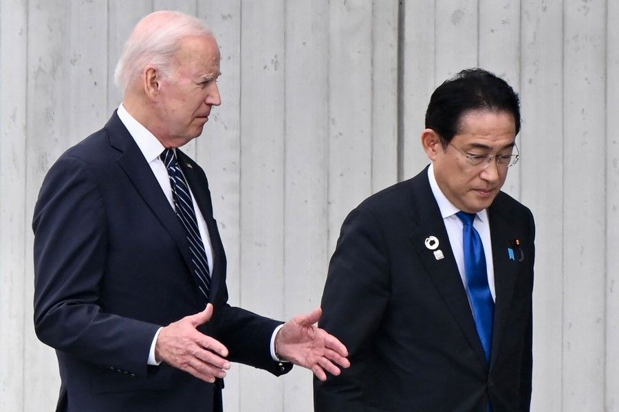 US President Joe Biden (left) talks to Japan's Prime Minister Fumio Kishida as they walk to take part in a wreath laying ceremony as part of the G7 Leaders' Summit in Hiroshima on 19 May 2023. (Kenny Holston/AFP)