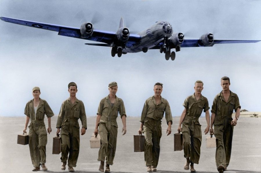 An airport in China, 15 September 1944. A B-29 bomber takes off after repairs, having lost two engines and one of its landing gear, as well as taking many hits to its ammunition hold. It was these American technicians who performed the repairs. From left: Sgt. Francis L. Daly, Sgt. Franklin W. Brian, twins Sgt. Lawrence C. Warne and Leonard J. Warne, Sgt. George P. Klein, and Sgt. Eugene W. Fiely. The US not only assisted with planes, but also brought many ground crew and technicians to China.