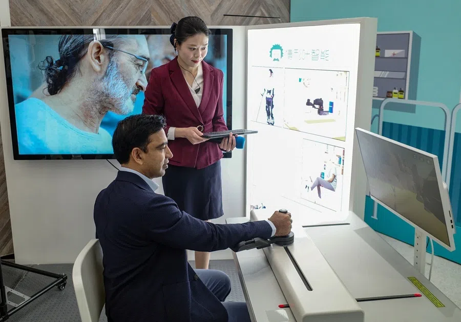 A man controls a medical robot at Zhangjiang Robot Valley Exhibition Hall during a tour for foreign investors in Shanghai, China, on 20 April 2026.