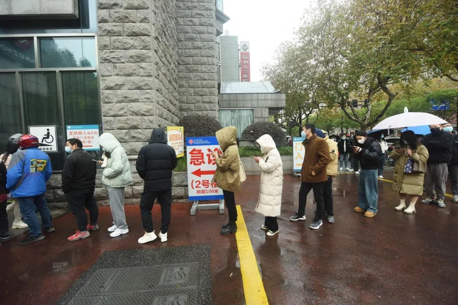 People queue to be tested for Covid-19 coronavirus outside a hospital in Hangzhou, in China's eastern Zhejiang province on 16 December 2022. (AFP)