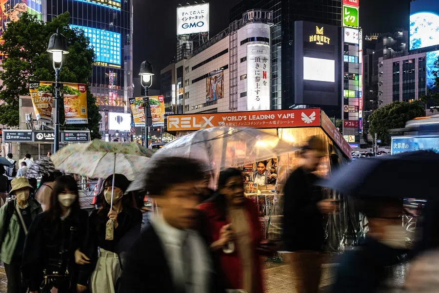 People walk in Tokyo’s Shibuya district, in Japan on 18 April 2024. (Philip Fong/AFP)