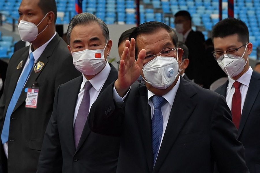 Cambodia's Prime Minister Hun Sen (second from right) gestures as Chinese Foreign Minister Wang Yi (centre, left) looks on as they attend a handover ceremony of the Morodok Techo National Stadium, funded by China's grant aid under its Belt and Road Initiative, in Phnom Penh, Cambodia, on 12 September 2021. (Tang Chhin Sothy/Pool/AFP)
