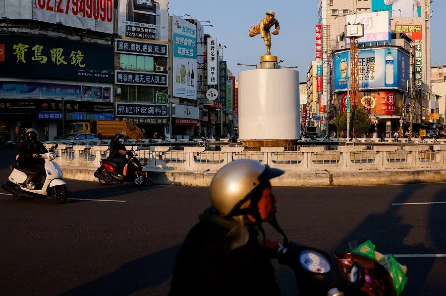 People drive by a landmark in Chiayi, Taiwan, on 24 March 2025.