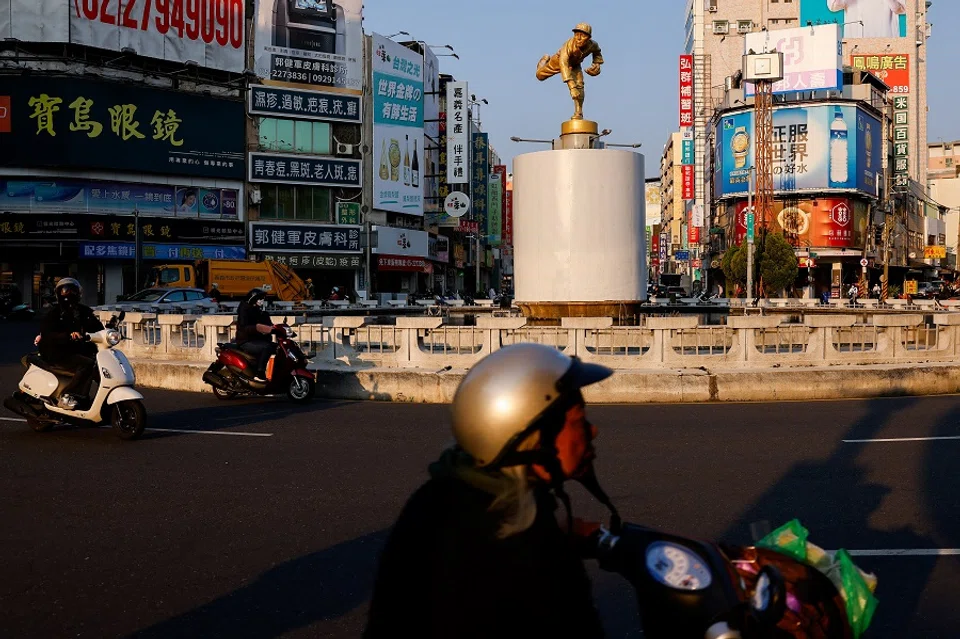 People drive by a landmark in Chiayi, Taiwan, on 24 March 2025. (Ann Wang/Reuters)
