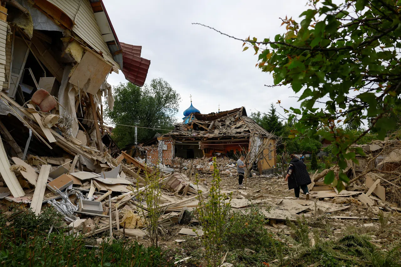 Residents are seen next to houses heavily damaged by a Russian drone strike, amid Russia’s attack on Ukraine, outside of Kyiv, Ukraine, on 18 May 2025. (Valentyn Ogirenko/Reuters)