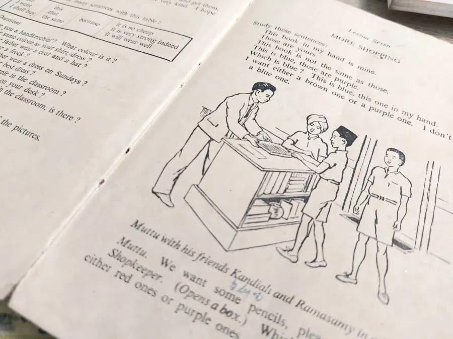 A page from an English textbook showing a dialogue between characters of various races in a provision shop.