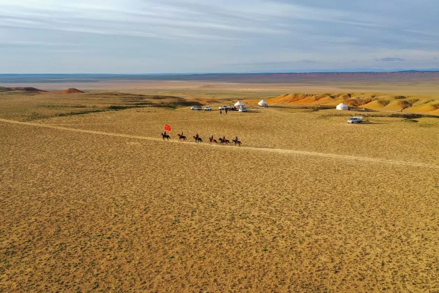 This photo taken on 22 April 2021 shows police officers and staff members riding horses as they prepare to publicise laws and government policy to nomad herders in a remote area in Altay in China's northwestern Xinjiang region. (STR/AFP)