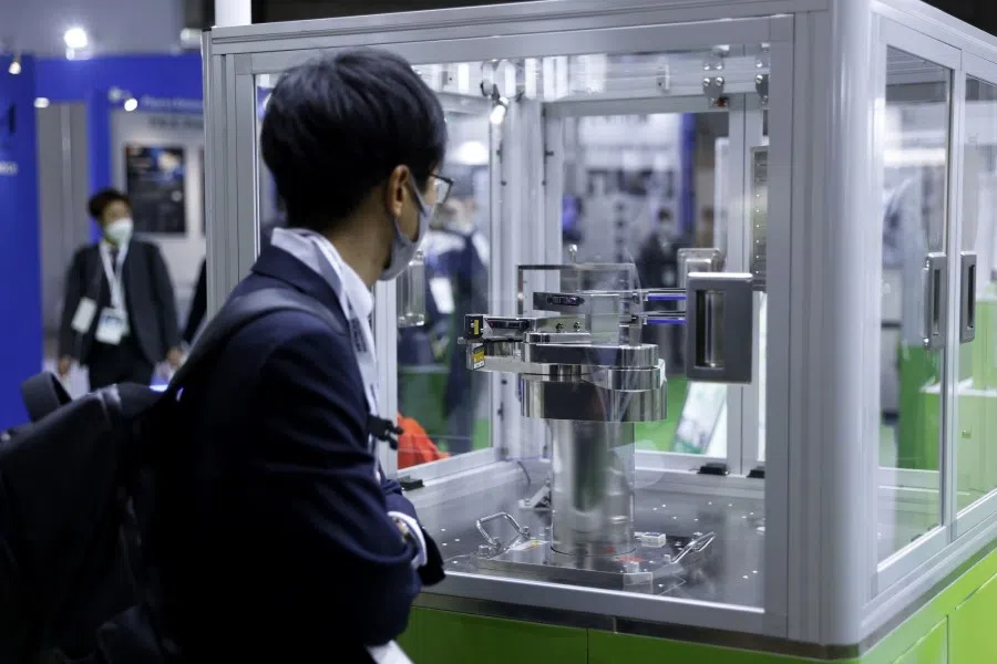 A visitor looks at Hiwin Technologies Corp.'s wafer robot at the Hiwin Corp. booth at the Semicon Japan exhibition in Tokyo, Japan, on 14 December 2022. (Kiyoshi Ota/Bloomberg)