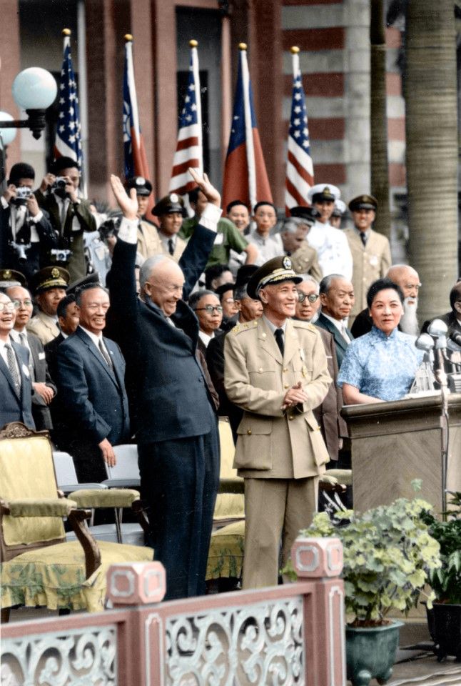 US President Eisenhower raises his arms in response to the crowd of 100,000 cheering him as he speaks in front of the Presidential Office Building.