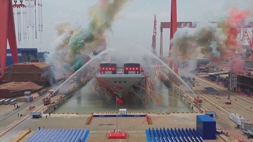 This screen grab made from a video released by Chinese state broadcaster CCTV shows the launch ceremony of the Fujian, a People's Liberation Army (PLA) aircraft carrier, at a shipyard in Shanghai, China, on 17 June 2022. (CCTV/AFP)